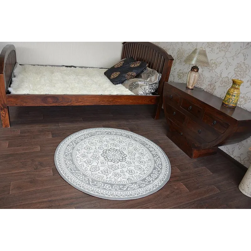 Tappeto circolare grigio in sisal, perfetto per interni eleganti