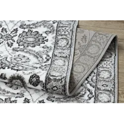 Tappeto strutturato grigio con fiori per la camera da letto