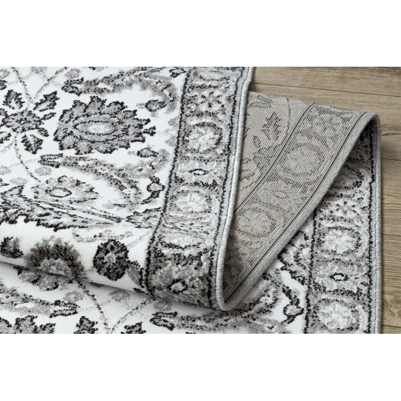 Tappeto strutturato grigio con fiori per la camera da letto